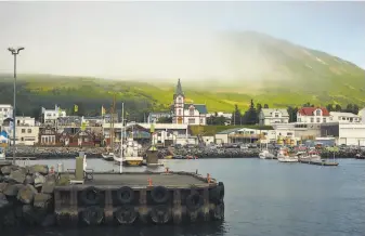  ?? Photos by Suzie Howell / New York Times ?? The village of Husavik is a popular whalewatch­ing area, but now there are fewer tourists.