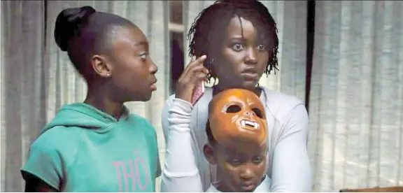  ?? UNIVERSAL PICTURES ?? Shahadi Wright Joseph, left, as Zora, Lupita Nyong’o as Adelaide Wilson and Evan Alex as Jason meet more than they bargained for in Jordan Peele’s horror film Us.