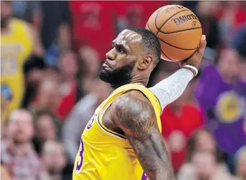  ?? CRAIG MITCHELLDY­ER/ THE ASSOCIATED PRESS ?? Los Angeles Lakers forward Lebron James slam dunks two of his 26 points in his Lakers debut against the Portland Trail Blazers on Thursday.