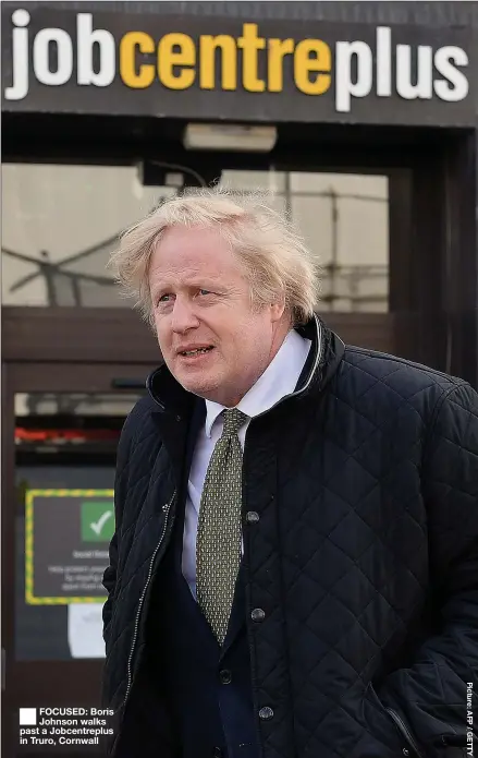  ??  ?? FOCUSED: Boris Johnson walks past a Jobcentrep­lus in Truro, Cornwall