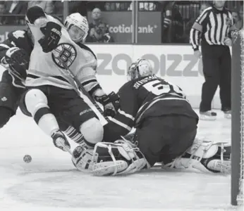  ?? STEVE RUSSELL/TORONTO STAR ?? Boston’s Jordan Caron barrels into Leaf goalie Jonas Gustavsson, leaving the door open for Chris Kelly to score.