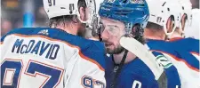  ?? DARRYL DYCK THE CANADIAN PRESS ?? Captains Connor McDavid of the Oilers and Quinn Hughes of the Canucks have a word after Game 7 in Vancouver.