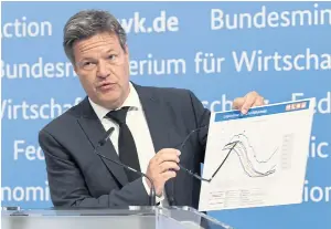  ?? REUTERS ?? German Economy Minister Robert Habeck shows a graph featuring forecasts of storage levels as he gives a press conference on energy supply security in Berlin yesterday.