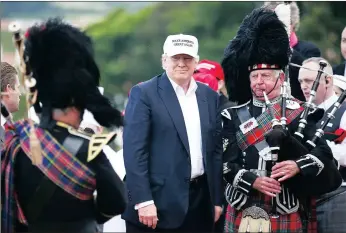  ?? PICTURE: AP ?? The presumptiv­e Republican presidenti­al nominee Donald Trump poses with a piper as he arrives at his revamped Trump golf course at Turnberry, Scotland yesterday.