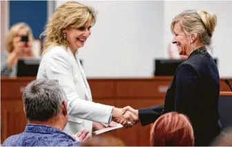  ?? Michael Wyke / For the Chronicle ?? Sharon Nowak, left, secretary for the Katy ISD board of trustees, congratula­tes Susan Gesoff, one of two new board members sworn in Monday. Gesoff is a former Katy ISD teacher.