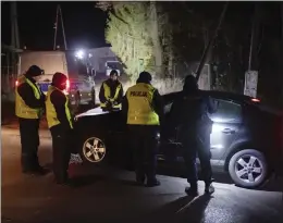  ?? THE ASSOCIATED PRESS ?? Police officers gather outside a grain depot in Przewodow, eastern Poland, on Tuesday where the Polish Foreign Ministry said a Russian-made missile fell and killed 2people.