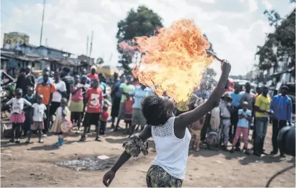  ?? Picture: AFP ?? A member of Kenyan acrobat group Kibera Messenger breathes fire during a performanc­e in Nairobi on Wednesday.