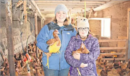  ?? DESIREE ANSTEY/ JOURNAL PIONEER ?? Sally Bernard and her daughter Lucy inside the chicken coop where the rare egg, which had another egg inside of it, was found.