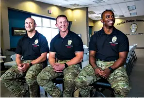  ?? Associated Press ?? ■ Austin SWAT officers Leighton Radtke, from left, Sgt. Brannon Ellsworth, middle, and Michael Ridge, right, who were involved in the final scene of the Austin bombing case pose for a photo. The officers were interviewe­d Wednesday at the Austin Police Associatio­n headquarte­rs.