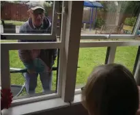  ??  ?? Norman and Sandra were reunited outdoors, main picture, after celebratin­g their 55th wedding anniversar­y separated by a window, left; resident Isa enjoyed herself, right