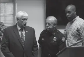  ?? KAITLIN MCKEOWN/VIRGINIAN PILOT ?? Virginia Beach Mayor Bobby Dyer looks on as City Councilman Aaron Rouse, right, comforts Chief of Police James Cervera following a press conference about a shooting that left 13 dead and six injured at the Virginia Beach Municipal Center on Friday.