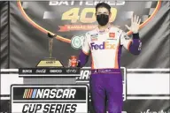  ?? Jamie Squire / Getty Images ?? Denny Hamlin celebrates after winning at Kansas Speedway on Thursday.