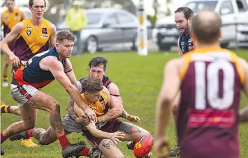  ?? ?? Below: Bairnsdale’s Link McKenna applies a strong tackle on Drouin’s Aden Quirk in the senior match.