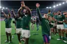  ??  ?? Cheslin Kolbe (right) holding his daughter Kayla, celebrates with teammates despite him missing the semi-final victory over Wales at Yokohama match because of an injury. Photograph: Tom Jenkins/The Guardian