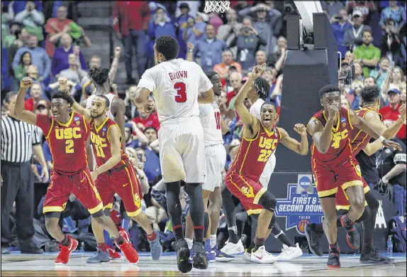  ?? TONY GUTIERREZ ASSOCIATED PRESS ?? SMU’s Sterling Brown (3) can only watch as USC’s Jonah Mathews (2), Jordan McLaughlin (11), De’Anthony Melton (22) and Chimezie Metu (4) celebrate their 66-65 win Friday. It was the Trojans’ second victory over SMU this season.