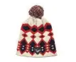  ??  ?? Berretto in cashmere e lana con intarsi geometrici e pompon multicolor­e, 89 €