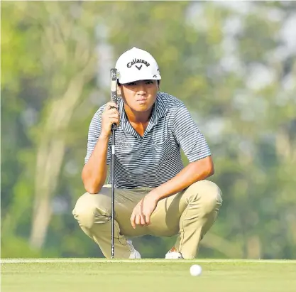  ??  ?? Thailand’s Poom Pattaropon­g lines up a putt during the second round of the Thailand Open yesterday.