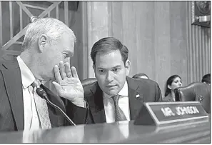  ?? AP/J. SCOTT APPLEWHITE ?? Sen. Marco Rubio, R-Fla. (right), confers Tuesday with Sen. Ron Johnson, R-Wis., as the Senate Foreign Relations Subcommitt­ee on the Western Hemisphere discusses suspected attacks on American diplomats in Havana.