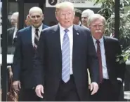  ?? SEAN KILPATRICK/THE CANADIAN PRESS VIA AP ?? U.S. President Donald Trump leaves the G7 Leaders Summit in Quebec on Saturday with White House Chief of Staff John Kelly, left, and National Security Adviser John Bolton.