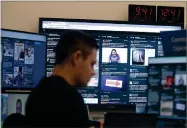  ?? AP FILE PHOTO BY JEFF CHIU ?? In this Oct. 17, photo, a man works at his desk in front of monitors during a demonstrat­ion in the war room, where Facebook monitors election related content on the platform, in Menlo Park, Calif.