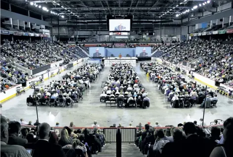  ?? HARLEY DAVIDSON/STANDARD STAFF ?? Hundreds of Jehovah's Witnesses gather at the Meridian Centre for a three-day convention as speaker Seth Hyatt (on screens) live streams from the Air Canada Centre. Over 4,500 Jehovah's Witnesses are expected to attend the St. Catharines convention...