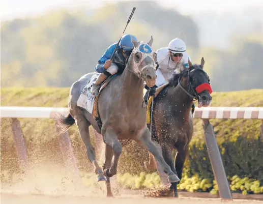  ?? SARAH STIER/GETTY ?? Essential Quality with Luis Saez up, left, wins the 153rd running of the Belmont Stakes on Saturday.