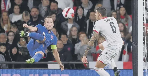  ?? ?? Harry Kane scores England’s fifth goal with an acrobatic scissor kick to complete his hat-trick against Albania at Wembley last night