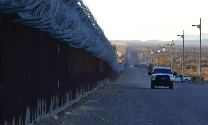  ?? ?? A US border patrol vehicle drives along the fence in Douglas, Arizona. Photograph: Ross D Franklin/AP