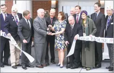 ??  ?? From left, holding scissors, Kevin Creed, volunteer CEO, director and founder of the Friends of Fisher House Connecticu­t; Mark L. Rivard, Disabled American Veterans state commander, and Blue Star mother Susan Strobino cut a ribbon to complete the...