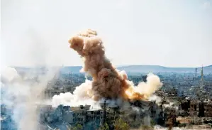  ?? AP ?? Smoke rises after Syrian government airstrikes and shelling hit Hajar Al Aswad neighbourh­ood held by Daesh militants, southern Damascus, Syria, on Sunday. —