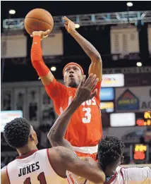  ?? ANDRES LEIGHTON/JOURNAL ?? New Mexico’s Keith McGee (3) takes aim at the basket in front of New Mexico State’s Keyon Jones on Tuesday night. McGee scored five points in the game.