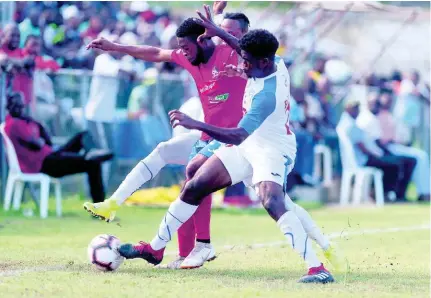  ?? GLADSTONE TAYLOR ?? Dean-Andre Thomas of Dunbeholde­n (left) is contested by Roshane Sharpe of Portmore United for possession of the ball in their Red Stripe Premier League match at the Spanish Town Prison Oval on September 15.