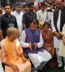  ?? — PTI ?? Uttar Pradesh chief minister Yogi Adiyanath with deputy chief minister Keshav Prasad Maurya before funeral of his father Shyam Lal Maurya at Sirathu village in Kaushambi district on Sunday.