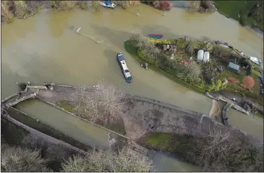  ?? (File Photo/AP/Frank Augstein) ?? A narrow boat sits in the floods of the river Thames on Jan. 7 in Oxford, England.