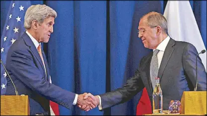  ??  ?? US Secretary of State John Kerry and Russian Foreign Minister Sergei Lavrov shake hands at the conclusion of a joint press conference following their meeting in Geneva, Switzerlan­d Friday.