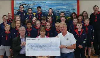  ??  ?? Geraldine Mooney, Joe Kirwin and Sean Olohan accepting the cheque from the Wicklow Scouts.