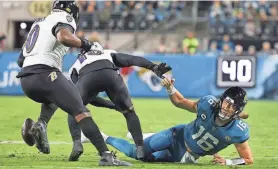  ?? COREY PERRINE/FLORIDA TIMES-UNION ?? Jaguars QB Trevor Lawrence fumbles during the Dec. 17 game against the Ravens at EverBank Stadium in Jacksonvil­le.