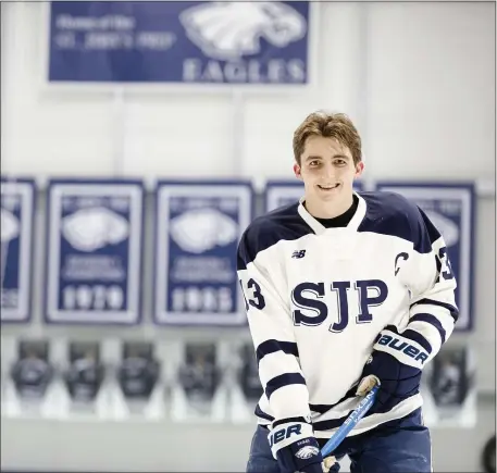  ?? LIBBY O’NEILL — BOSTON HERALD ?? Senior Jake Vana is a captain on the St. John Prep’s hockey team and a champion on and off the ice.