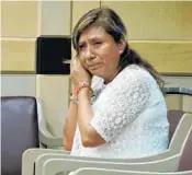  ?? RAFAEL OLMEDA/STAFF ?? A handcuffed Nancy Gayoso removes her earrings as she prepares to be taken to prison to serve a five-year sentence for manslaught­er in the death of Rosita Gonzalez.