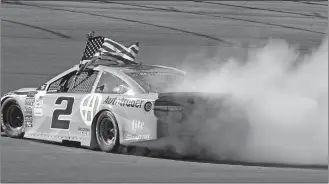  ?? ISAAC BREKKEN/AP PHOTO ?? Brad Keselowski celebrates with a burnout after winning the NASCAR Cup race on Sunday.