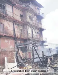  ??  ?? The scorched four-storey building