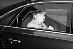  ??  ?? Merkel arrives in a car for a meeting with the leaders of the conservati­ve CDU/CSU union and the leader of the social democratic SPD party in Berlin. — AFP photo