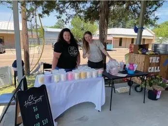  ?? (Contribute­d) ?? Mary Shoemaker, left, owner of Oh How Sweet Cotton Candy, and Kaila Emery, owner of the online boutique Steadfast Supply, smile next to the cotton candy booth at a fundraiser for The CALL of Union County on Saturday.