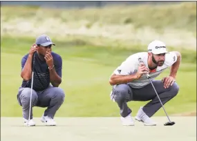  ?? Seth Wenig / Associated Press ?? Tiger Woods, left, and Dustin Johnson line up their putts on the 16th green during the first round of the U.S. Open on Thursday.