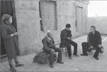  ??  ?? Liu (first from right) visits a local farmer’s house to learn about their situation;