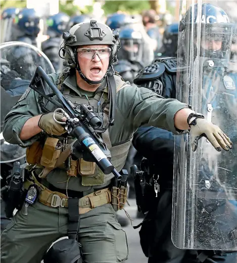  ?? AP ?? Riot police on the streets of America can be interprete­d as another sign of its recent democratic decline.
