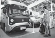  ?? PROVIDED TO CHINA DAILY ?? Visitors observe different types of clean-energy trucks on display at the Shenzhen Logistics Expo on Oct 12,2017.