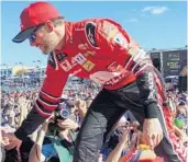  ?? JOE CAVARETTA/STAFF PHOTOGRAPH­ER ?? Dale Earnhardt Jr. greets fans prior to the Ford EcoBoost 400 on Sunday, the final race of his driving career.