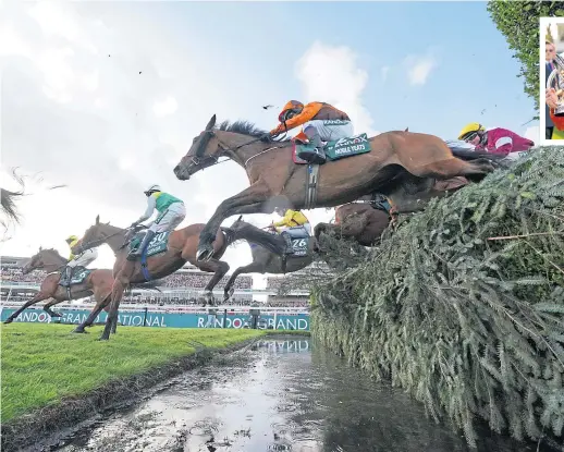  ?? ?? Noble Yeats, in orange and brown, clears the water jump on the way to winning the Grand National at Aintree yesterday, before jockey Sam Waleycohen, above, celebrates with trophy