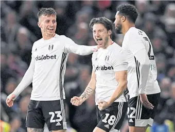  ??  ?? Fulham players celebrate scoring a goal in the FA Cup. They are third in the Championsh­ip behind Leeds on goal difference.